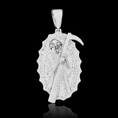White gold Grim Reaper pendant fully set with micropavé stones, featuring a detailed skull and diamond-set scythe on a black background.